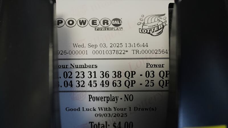 A Powerball lottery ticket is printed out of a lottery machine at a convenience store in...